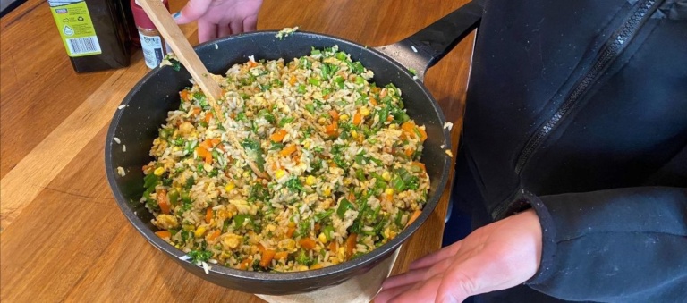 High school students collaboratively cook a colourful meal, embodying the spirit of community and the heart of shared nourishment.
