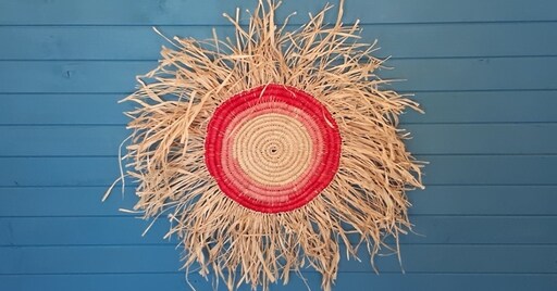 Hand-woven fibre sunburst celebrates Kindlehills respectful connection to Dharug Country, language restoration and vibrant community spirit.