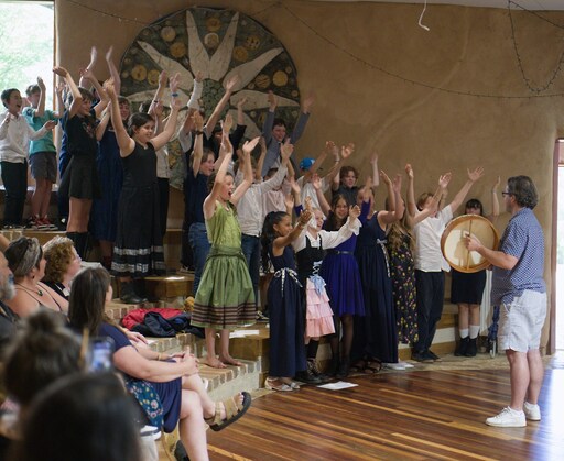 Kindlehill students celebrate graduation milestones through joyous communal song, honouring their shared journey within a vibrant school village.