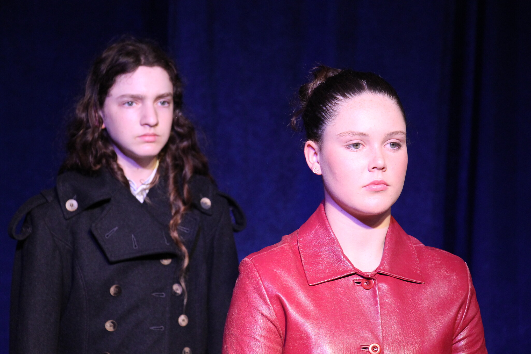 Kindlehill students demonstrate focused resilience during a contemporary dramatic performance of Antigone on the school stage.