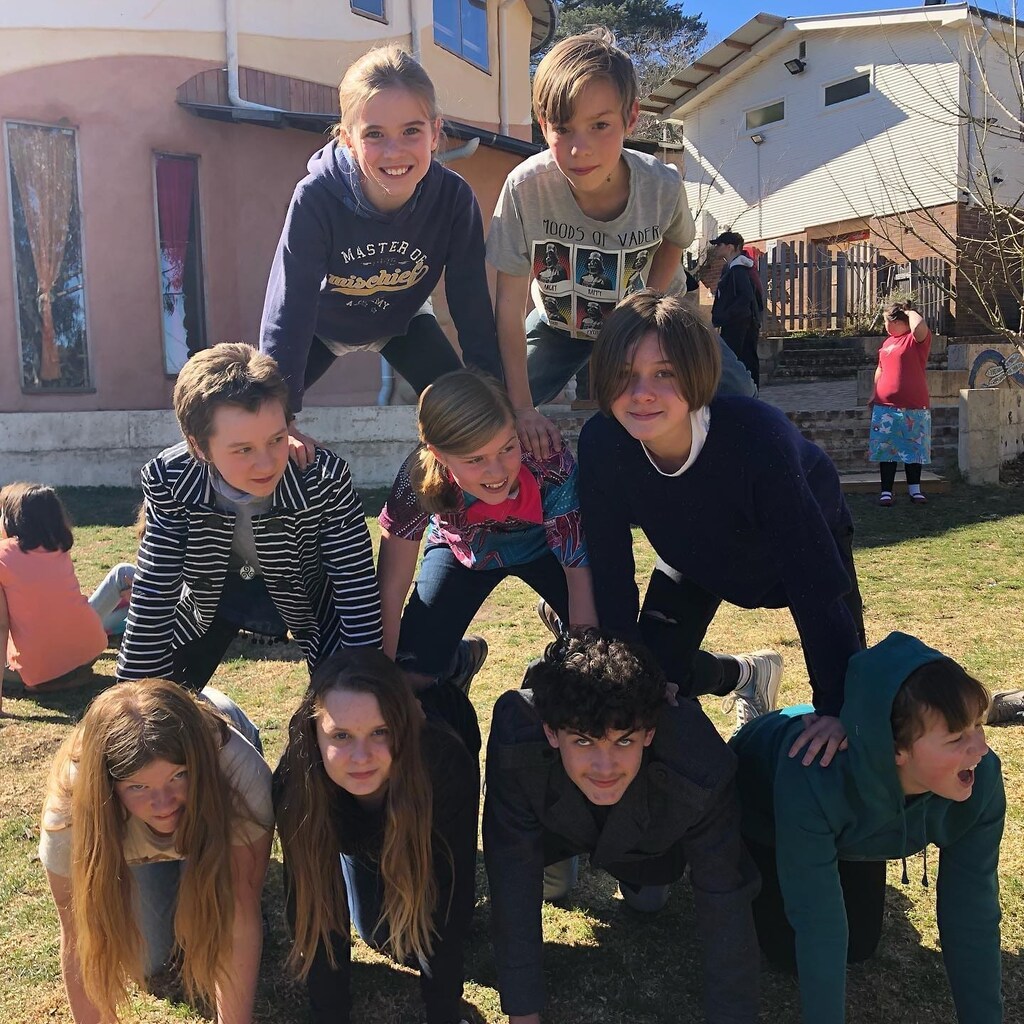 Students form a cooperative human pyramid, showcasing the warm spirit of community and connection at Kindlehill.