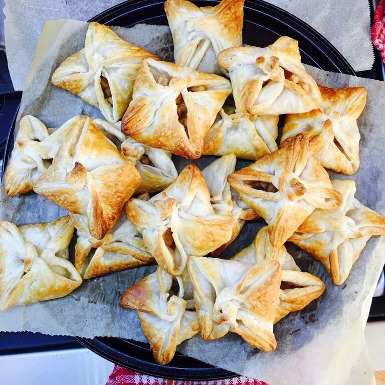 Hand-baked golden star pastries nourish the Kindlehill village, celebrating seasonal rhythms and heart-centred community connection.