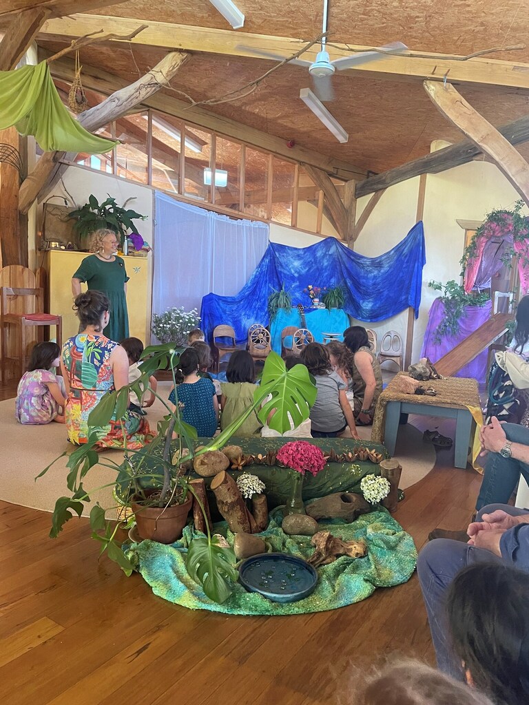 Kindlehill families gather for storytelling, awakening imagination through a nature-centred community rhythm and shared sense of wonder.