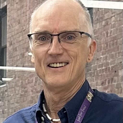 Smiling educator at the heart of our Kindlehill village, fostering connection and honouring every childs developmental journey.