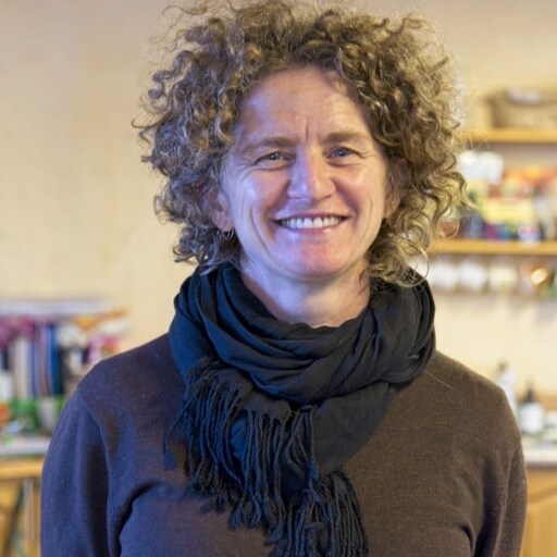 A smiling educator radiates Kindlehills warm community spirit, fostering heart-centred connection and trust for every growing child.