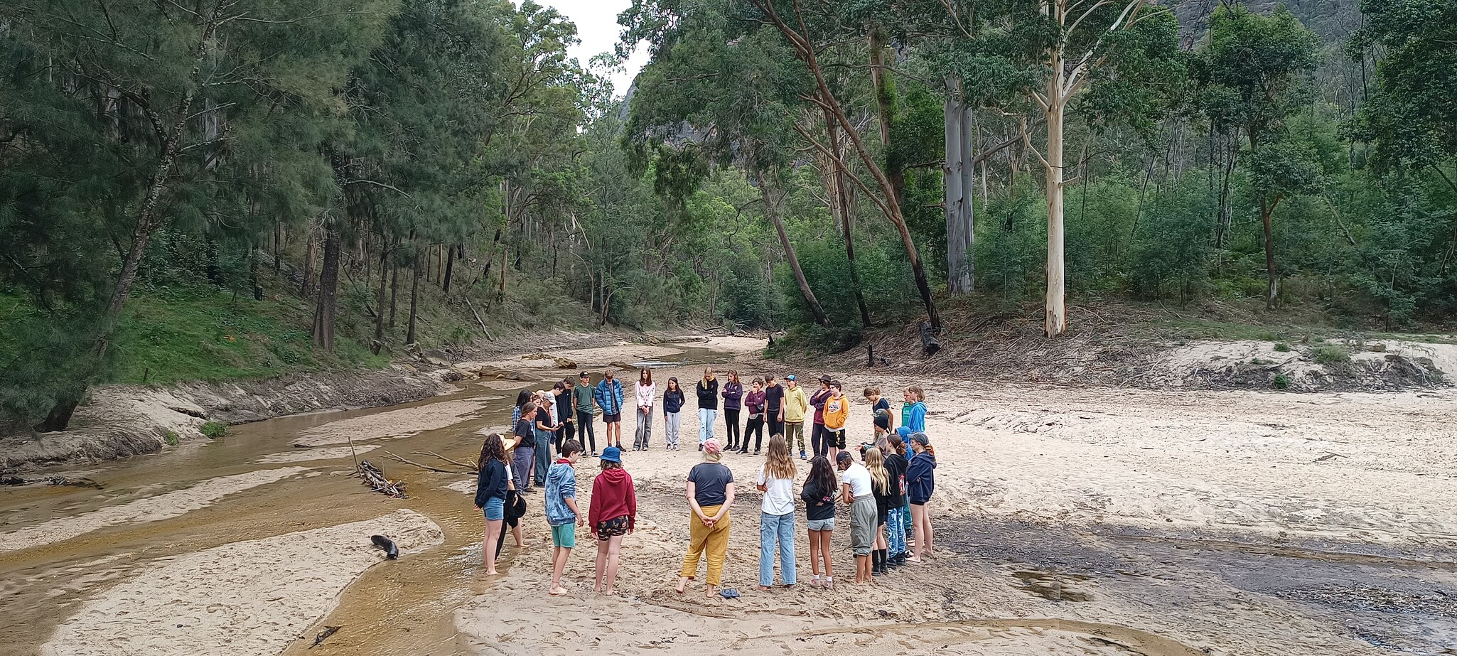 Kindlehill students gather in a circle on Country, honouring the seasonal rhythm and fostering a shared sense of belonging.