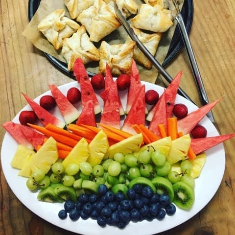 Vibrant fruit and pastries nourish the school community, fostering a shared sense of belonging through natures seasonal rhythms.