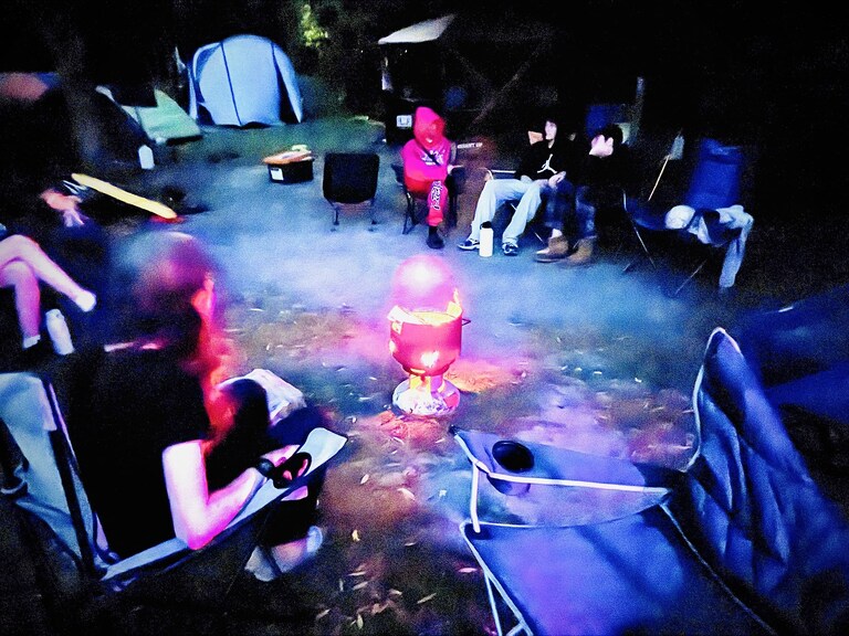 Kindlehill students share stories around a campfire, fostering community connection and resilience under the open Blue Mountains sky.