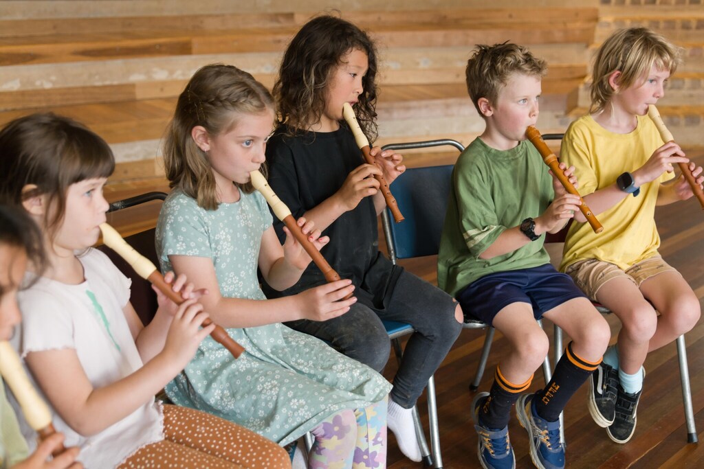 Kindlehill students play recorders together, fostering harmony and artistic expression through a shared community breath.