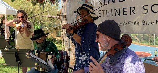 Kindlehill community musicians perform together, cultivating deep connection and a shared sense of purpose through inclusive musical collaboration.