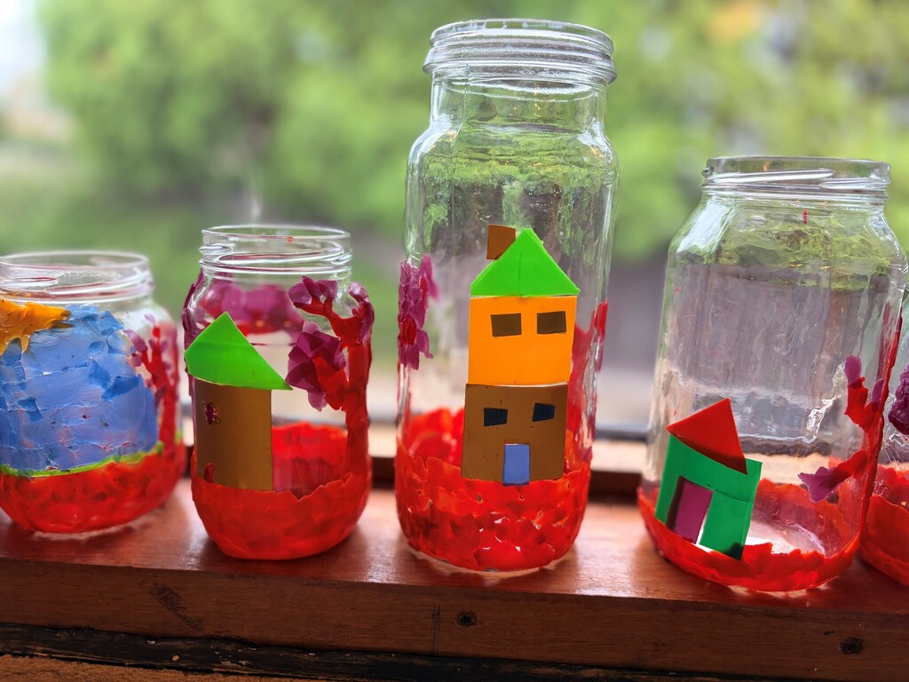 Hand-decorated lanterns featuring colourful houses and blossoms symbolise the inclusive village where every Kindlehill family truly belongs.