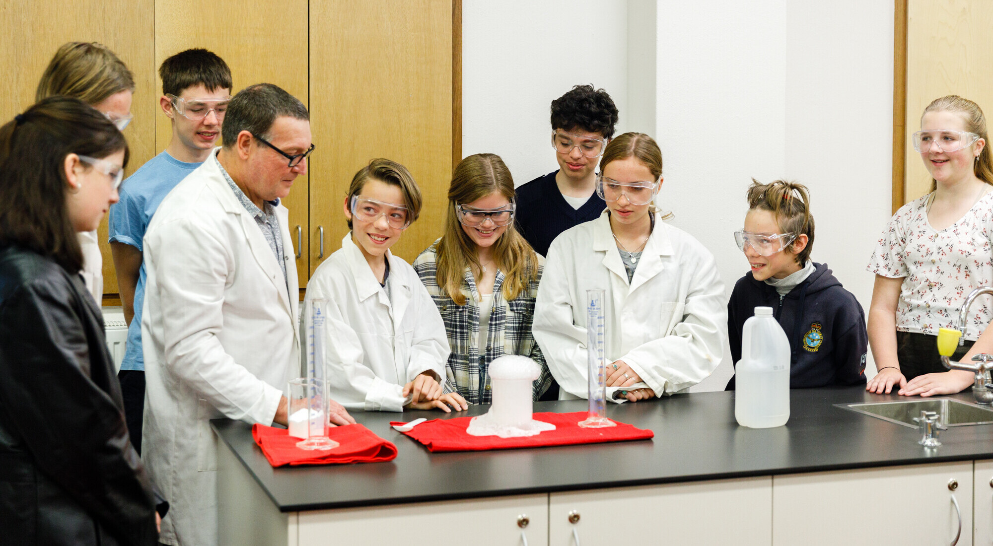 Kindlehill students and their teacher share wonder, awakening curiosity through collaborative scientific discovery within a supportive learning environment.